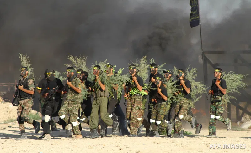 Militants of the Palestinian Islamic Jihad demonstrate their skills during a graduation ceremony in Nusirat in the central Gaza Strip July 28, 2011. Photo by Ashraf Amra