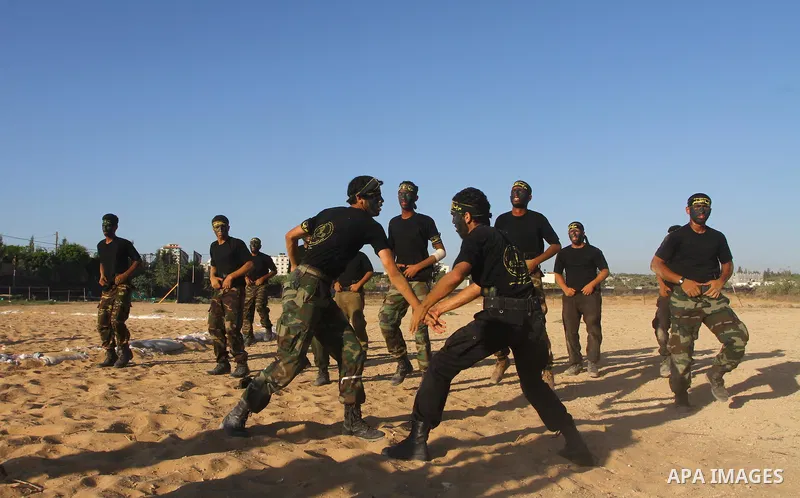Militants of the Palestinian Islamic Jihad demonstrate their skills during a graduation ceremony in Nusirat in the central Gaza Strip July 28, 2011. Photo by Ashraf Amra