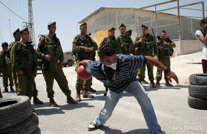 Protesters argue with an Israeli soldiers during a demonstration against Israel's controversial separation barrier in the West Bank village of Maasarah, near the biblical town of Bethlehem on 29 July 2011. Israel says th...