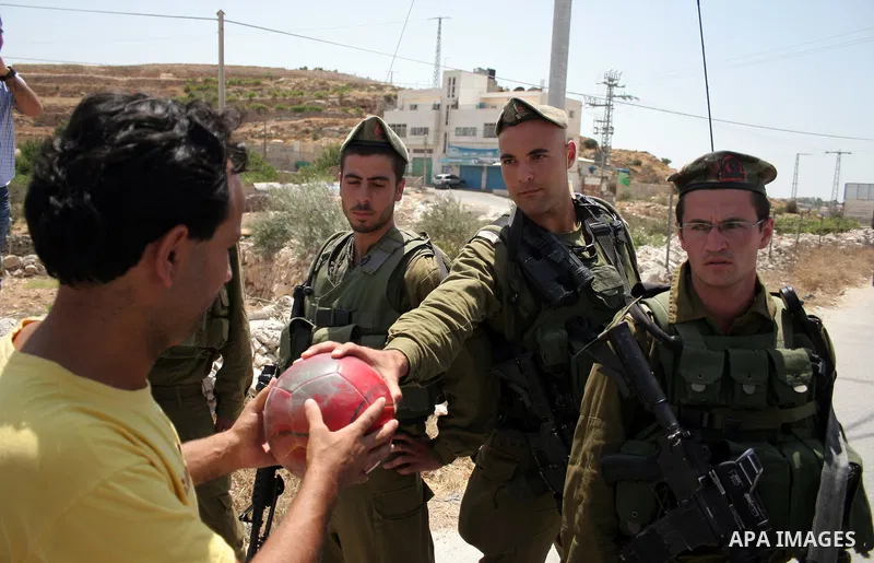 Protesters argue with an Israeli soldiers during a demonstration against Israel's controversial separation barrier in the West Bank village of Maasarah, near the biblical town of Bethlehem on 29 July 2011. Israel says th...
