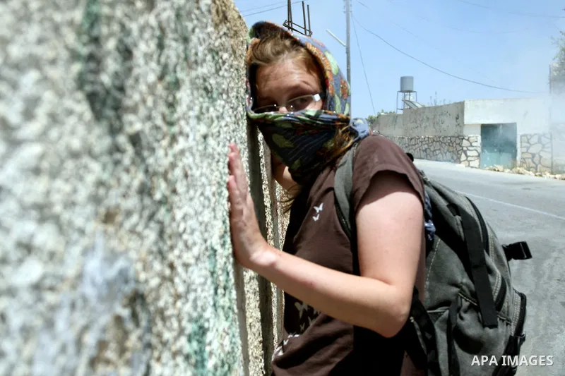 Pro-Palestinian protesters run away from tear gas fired by Israeli security force officers during clashes at a weekly protest in the West Bank village of Nabi Saleh, near Ramallah July 29, 2011. Photo by Issam Rimawi