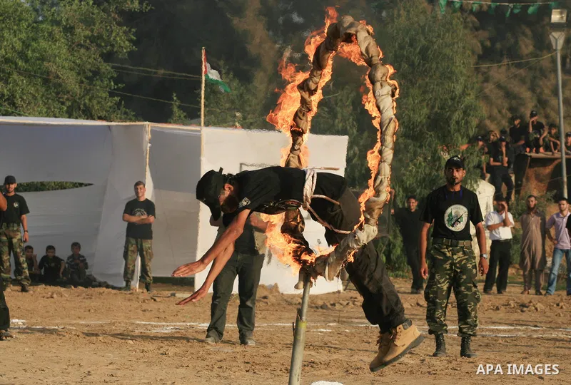New graduates of a Palestinian Hamas military camp, ages 12-18, perform mock exercises during a graduation ceremony in Gaza City, on July 29, 2011. Photo by Majdi Fathi