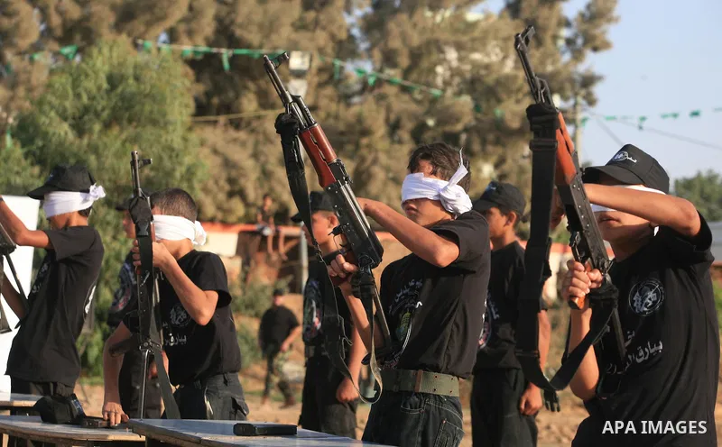 New graduates of a Palestinian Hamas military camp, ages 12-18, perform mock exercises during a graduation ceremony in Gaza City, on July 29, 2011. Photo by Majdi Fathi