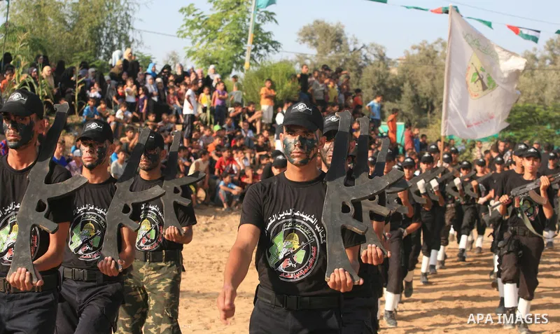 New graduates of a Palestinian Hamas military camp, ages 12-18, perform mock exercises during a graduation ceremony in Gaza City, on July 29, 2011. Photo by Majdi Fathi