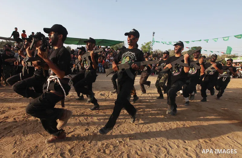 New graduates of a Palestinian Hamas military camp, ages 12-18, perform mock exercises during a graduation ceremony in Gaza City, on July 29, 2011. Photo by Majdi Fathi