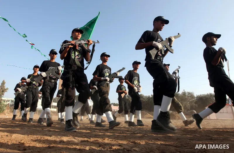 New graduates of a Palestinian Hamas military camp, ages 12-18, perform mock exercises during a graduation ceremony in Gaza City, on July 29, 2011. Photo by Majdi Fathi