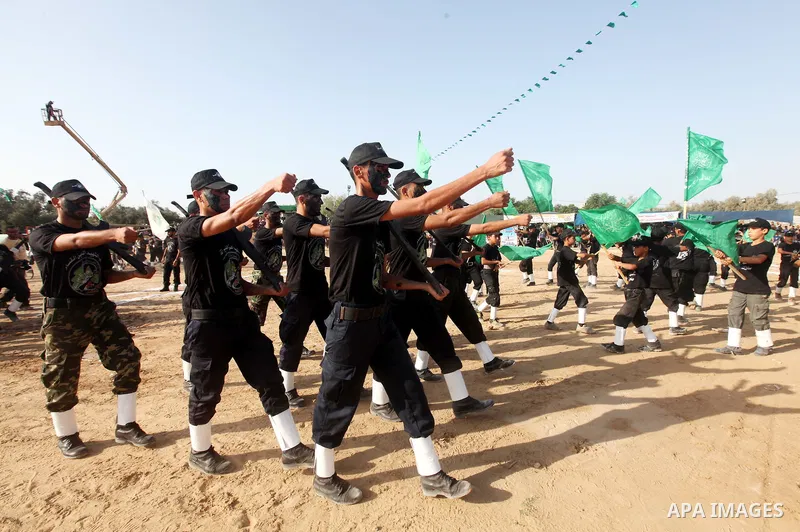 New graduates of a Palestinian Hamas military camp, ages 12-18, perform mock exercises during a graduation ceremony in Gaza City, on July 29, 2011. Photo by Majdi Fathi