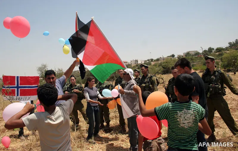 Palestinian protesters argue with Israeli soldiers during a demonstration against Israel's controversial separation barrier in the West Bank village of Beit Omar, near Hebron, 30 July 2011. Israel says the network of ste...