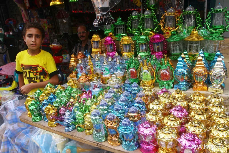 A Palestinian boy hangs Plastic lanterns outside his shop ahead of the Muslim holy fasting month of Ramadan at Al-Zawiya market in Gaza City on July 30, 2011. Photo by Ashraf Amra