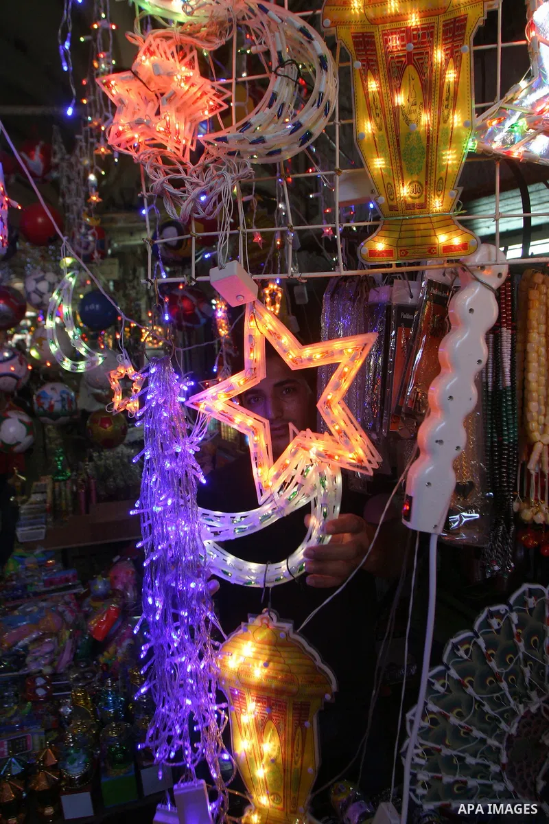 Palestinians walks under decorations ahead of the Muslim holy month of Ramadan in Jerusalem's Old City July 30, 2011. Muslims around the world abstain from eating, drinking and sexual relations from sunrise to sunset dur...