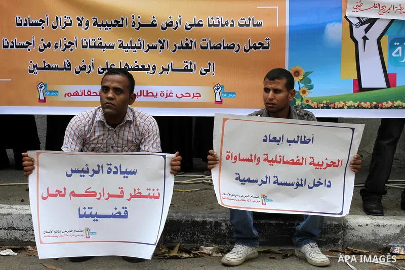 Palestinians wounded, take part in a protest demanding the authority of Ramallah to grant them their rights and entitlements in Gaza city on July 31, 2011. Photo by Mohammed Asad