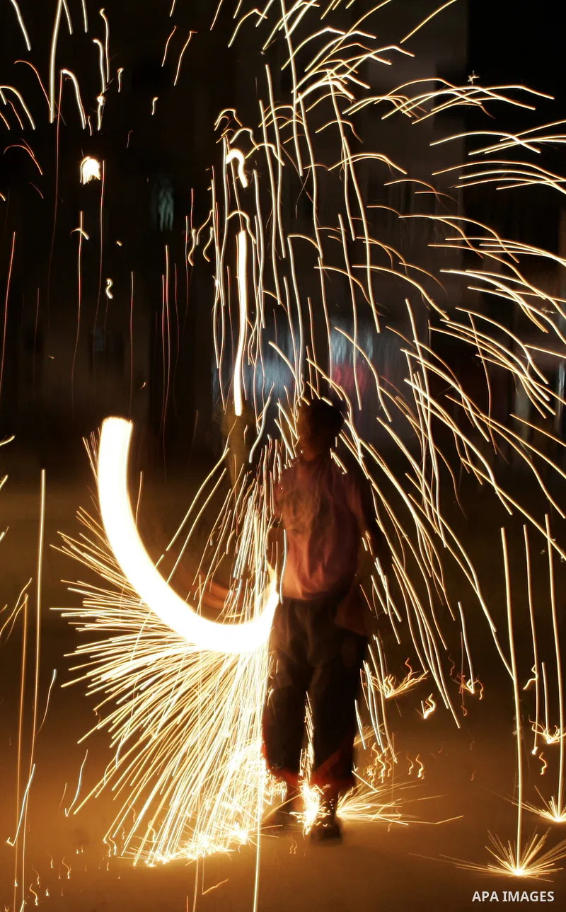 A Palestinian boy plays with fire crackers celebrating ahead of the Muslim holy month of Ramadan, in Rafah, southern Gaza Strip on July 30, 2011, where today is the complement of the month of Sha'ban, and tomorrow is the...