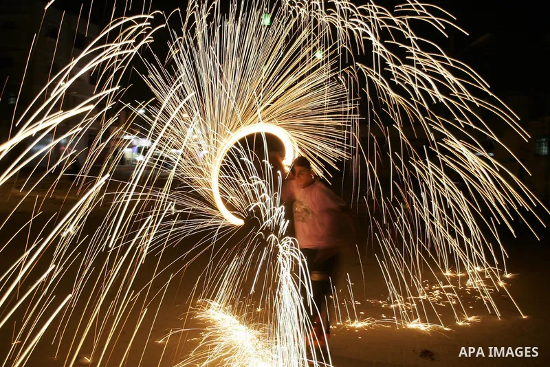 A Palestinian boy plays with fire crackers celebrating ahead of the Muslim holy month of Ramadan, in Rafah, southern Gaza Strip on July 30, 2011, where today is the complement of the month of Sha'ban, and tomorrow is the...