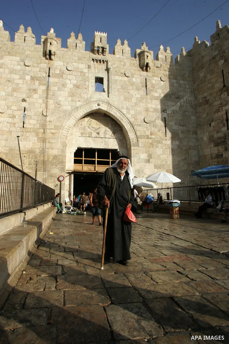 Palestinians are walk at the entrance of the Al-Aqsa mosque compound, in the old city of Jerusalem, on July 31 2011, as people ready for the upcoming Muslim holy fasting month of Ramadan. Photo by Mahfouz Abu Turk