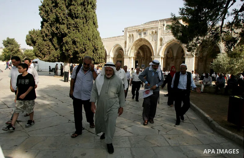 Palestinians are walk at the entrance of the Al-Aqsa mosque compound, in the old city of Jerusalem, on July 31 2011, as people ready for the upcoming Muslim holy fasting month of Ramadan. Photo by Mahfouz Abu Turk
