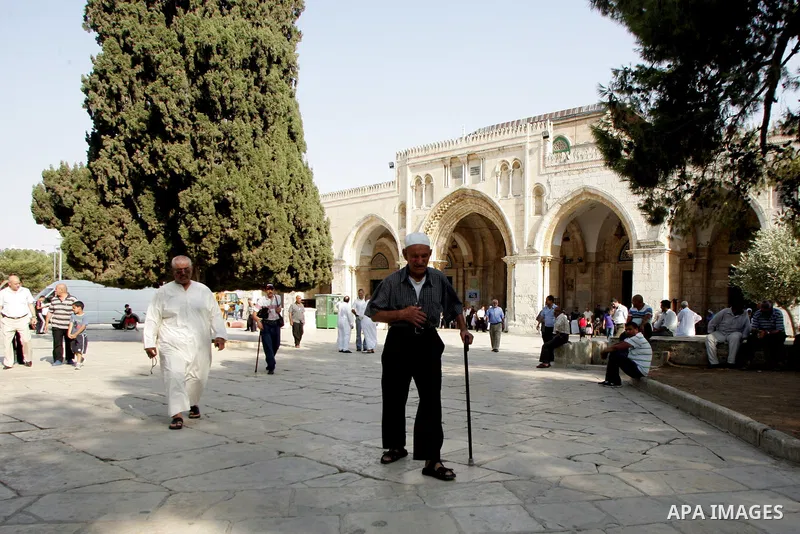 Palestinians are walk at the entrance of the Al-Aqsa mosque compound, in the old city of Jerusalem, on July 31 2011, as people ready for the upcoming Muslim holy fasting month of Ramadan. Photo by Mahfouz Abu Turk