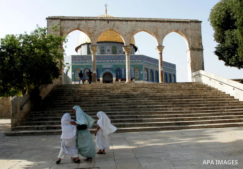 Palestinians are walk at the entrance of the Al-Aqsa mosque compound, in the old city of Jerusalem, on July 31 2011, as people ready for the upcoming Muslim holy fasting month of Ramadan. Photo by Mahfouz Abu Turk