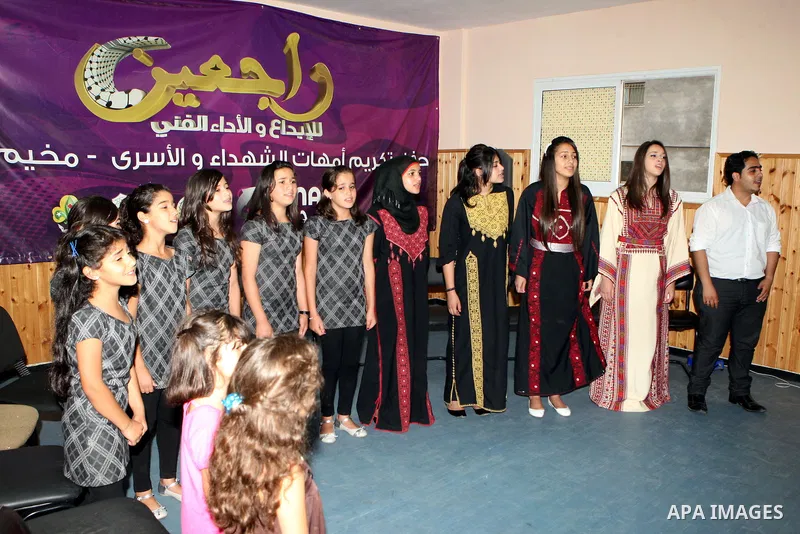 Palestinian Prime Minister, Salam Fayyad during his visit to the Palestinian Child Club and the band coming back "Rageen" in al-Amari Refugee Camp in the west Bank city of Ramallah on July 31, 2011. Photo by Mustafa Abu...
