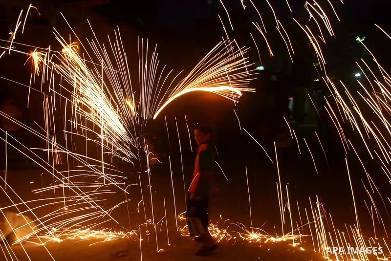 A Palestinian boy plays with fire crackers celebrating ahead of the Muslim holy month of Ramadan, in Der El-Balah southern Gaza Strip on July 31, 2011, where today is the complement of the month of Sha'ban, and tomorrow...