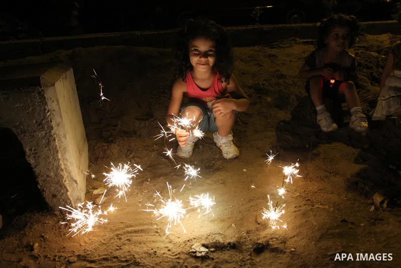 A Palestinian girl enjoys playing with fire crackers celebrating ahead of the Muslim holy month of Ramadan in Gaza city on July 31, 2011. Photo by Mohammed Asad