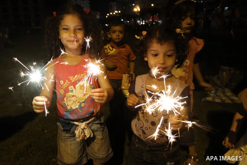 Palestinian girls enjoy playing with fire crackers celebrating ahead of the Muslim holy month of Ramadan in Gaza city on July 31, 2011. Photo by Mohammed Asad