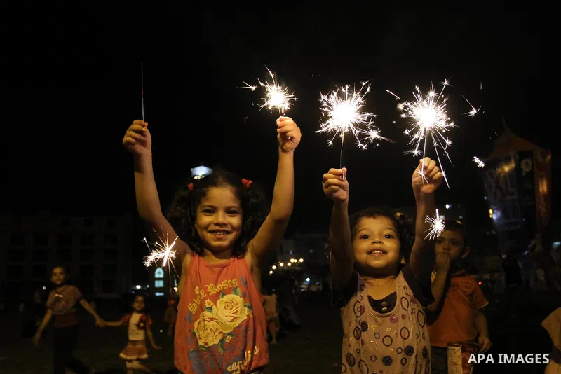 Palestinian girls enjoy playing with fire crackers celebrating ahead of the Muslim holy month of Ramadan in Gaza city on July 31, 2011. Photo by Mohammed Asad