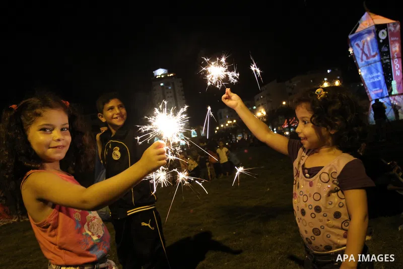 Palestinian girls enjoy playing with fire crackers celebrating ahead of the Muslim holy month of Ramadan in Gaza city on July 31, 2011. Photo by Mohammed Asad