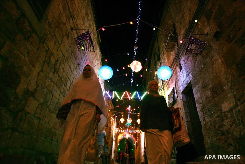 Palestinians walks under decorations ahead of the Muslim holy month of Ramadan in Jerusalem's Old City. Muslims around the world abstain from eating, drinking and sexual relations from sunrise to sunset during Ramadan, t...