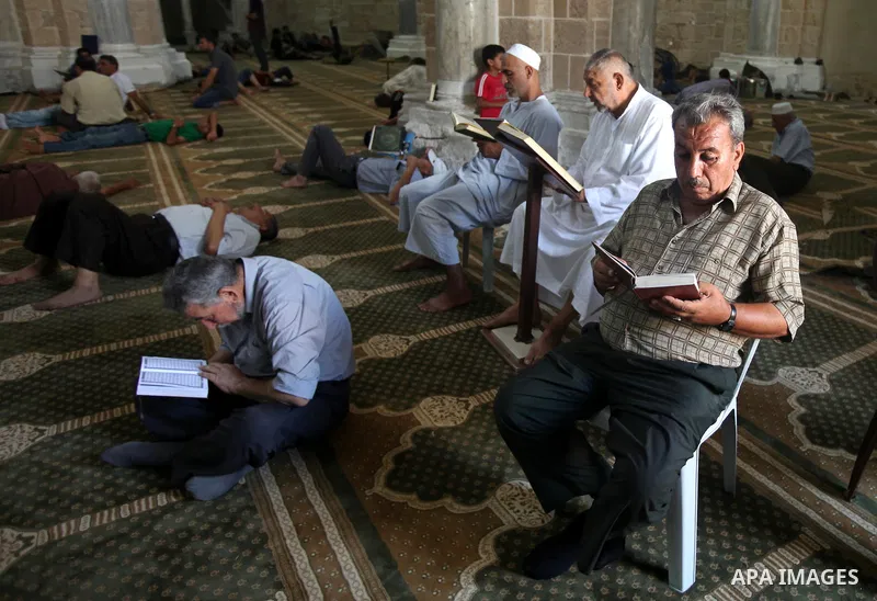 A Palestinian man reads the holy koran on the first day of holy fasting month of Ramadan at al-Omari mosque in Gaza city on Aug. 1, 2011. Throughout the holy month of Ramadan devout Muslims must abstain from food, drink...