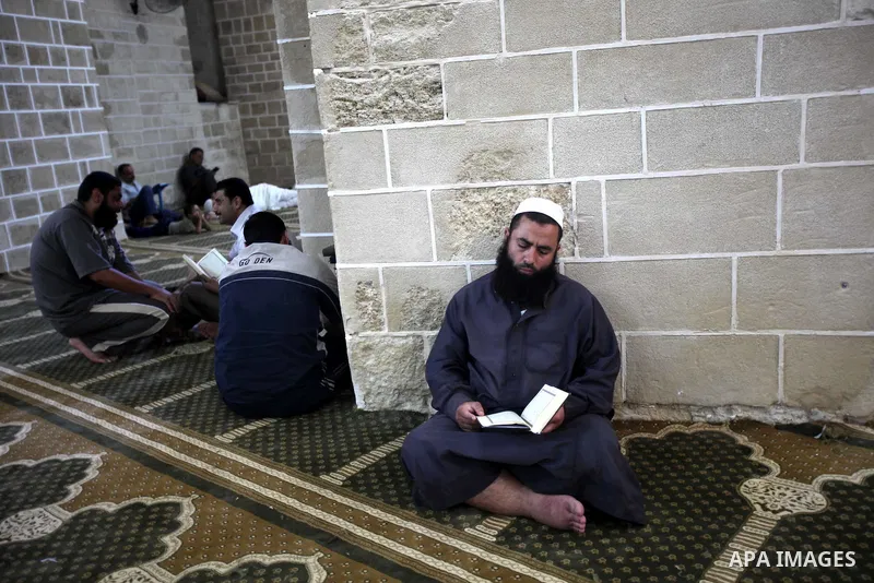 A Palestinian man reads the holy koran on the first day of holy fasting month of Ramadan at al-Omari mosque in Gaza city on Aug. 1, 2011. Throughout the holy month of Ramadan devout Muslims must abstain from food, drink...