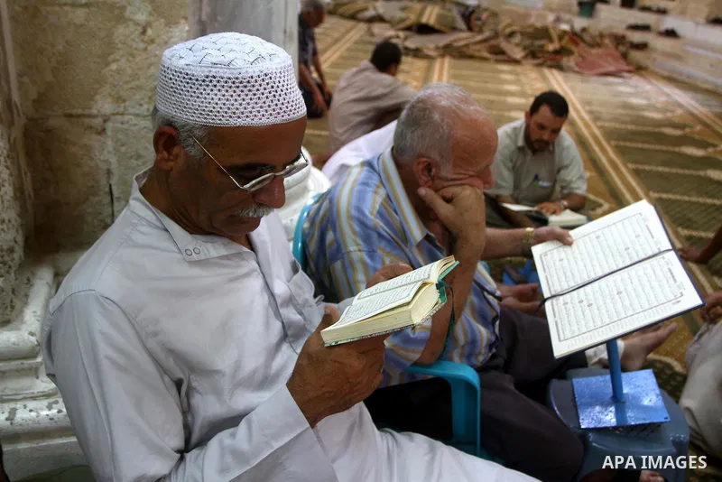 Palestinian men read the holy koran on the first day of holy fasting month of Ramadan at al-Omari mosque in Gaza city on Aug. 1, 2011. Throughout the holy month of Ramadan devout Muslims must abstain from food, drink and...