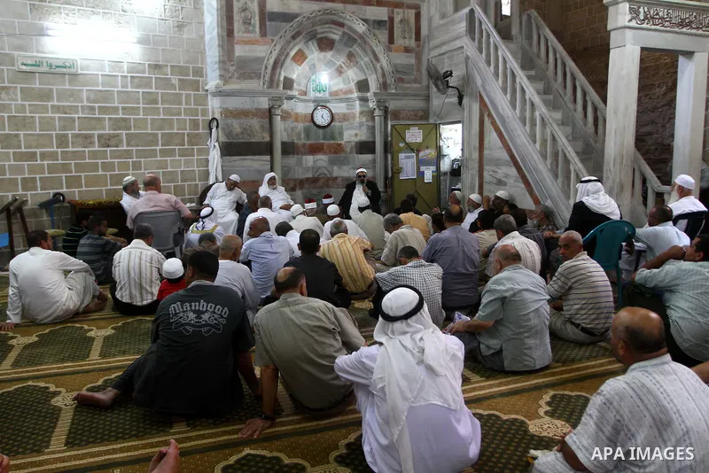 Palestinian men listen to the sermon on the first day of holy fasting month of Ramadan at al-Omari mosque in Gaza city on Aug. 1, 2011. Throughout the holy month of Ramadan devout Muslims must abstain from food, drink an...