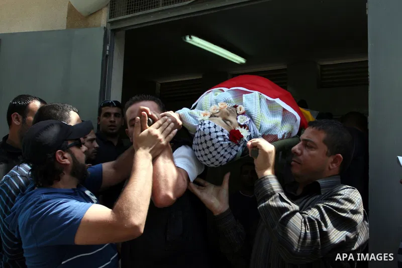 Palestinians carry the body of Moutasm Eidwan, 23, during their funeral at the West bank refugee camp of Kalandia, near Ramallah, 01 August 2011, on the first day of the Muslim holy month of Ramadan. Reports state that I...