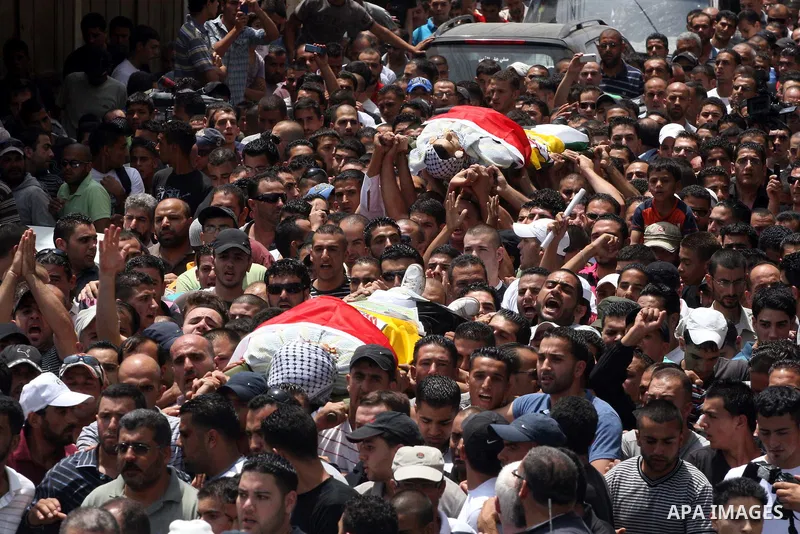 Palestinian mourners carry the bodies of Moatassem Adwan, 23, and Ali Khalifa, 22, during their funeral on August 1, 2011 after the two Palestinians were shot dead overnight by Israeli soldiers in the Qalandia refugee ca...