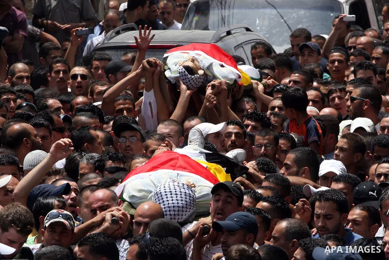 Palestinian mourners carry the bodies of Moatassem Adwan, 23, and Ali Khalifa, 22, during their funeral on August 1, 2011 after the two Palestinians were shot dead overnight by Israeli soldiers in the Qalandia refugee ca...