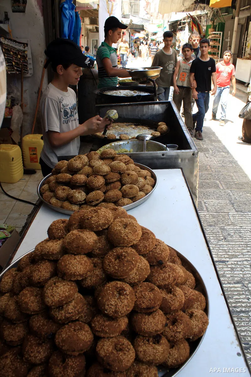 A Palestinian vendor prepares traditional foods "falafel" on the first day of the Muslim holy month of Ramadan, in a shop in the West Bank city of Nablus, Monday, Aug. 1, 2011. Muslims throughout the world are celebratin...