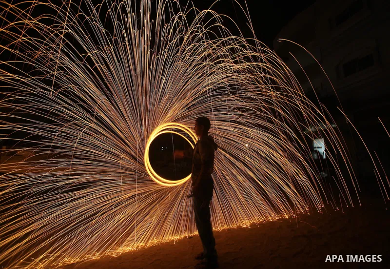 Palestinian boy plays with fireworks to celebrate the beginning of the Muslim holy fasting month of Ramadan in Gaza City on 01 August 2011. Muslims throughout the world are celebrating the holy fasting month of Ramadan,...