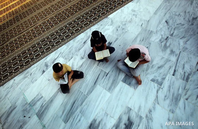 Palestinian boys read the Koran at the al-Omari mosque in Gaza City on the first day of the Muslim holy fasting month of Ramadan on 01 August 2011. Muslims throughout the world are celebrating the holy fasting month of R...