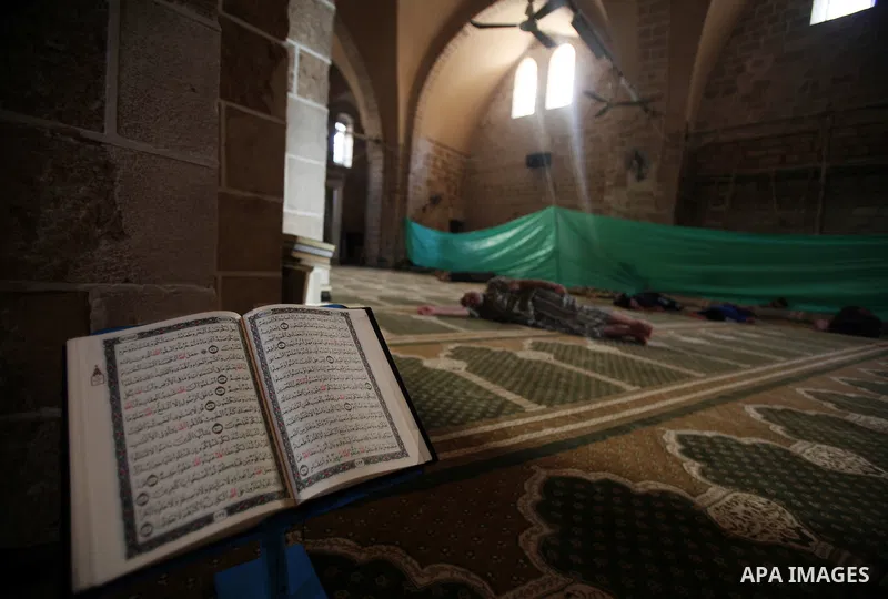 Palestinian boys read the Koran at the al-Omari mosque in Gaza City on the first day of the Muslim holy fasting month of Ramadan on 01 August 2011. Muslims throughout the world are celebrating the holy fasting month of R...