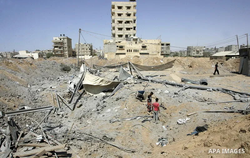 Palestinians inspect the damage outside a smuggling tunnel following an overnight Israeli airstrike in Rafah, on the border between Egypt and southern Gaza Strip, Tuesday, Aug 2, 2011. Israel bombed the tunnel in respons...
