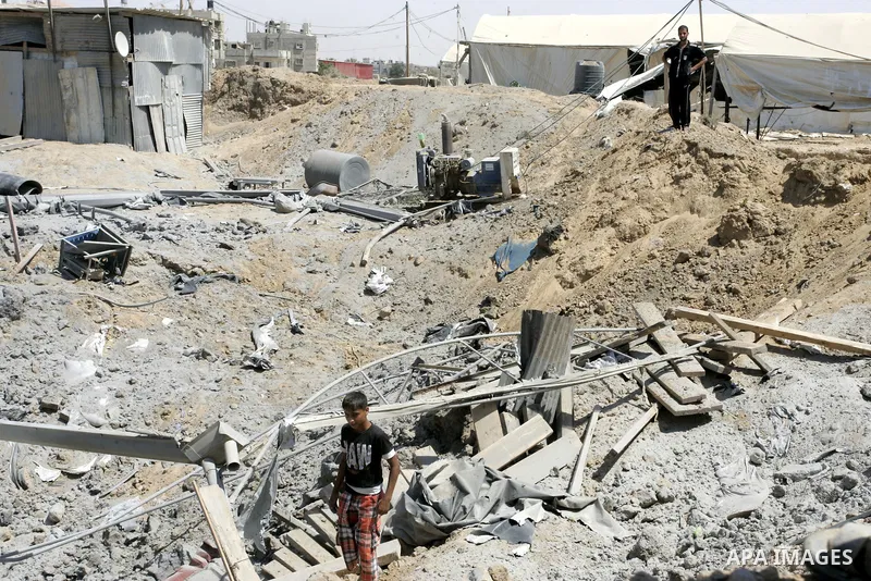 Palestinians inspect the damage outside a smuggling tunnel following an overnight Israeli airstrike in Rafah, on the border between Egypt and southern Gaza Strip, Tuesday, Aug 2, 2011. Israel bombed the tunnel in respons...