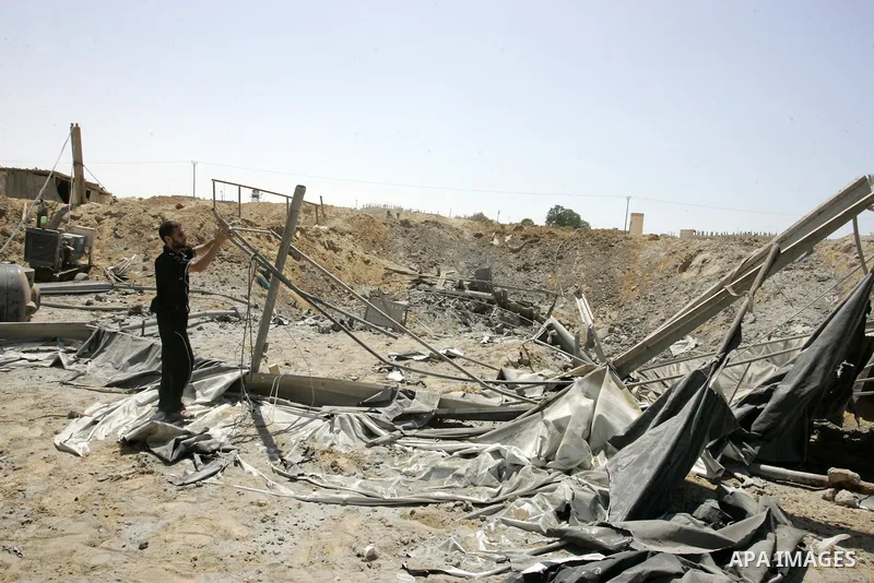 A Palestinians man inspects the damage outside a smuggling tunnel following an overnight Israeli airstrike in Rafah, on the border between Egypt and southern Gaza Strip, Tuesday, Aug 2, 2011. Israel bombed the tunnel in...
