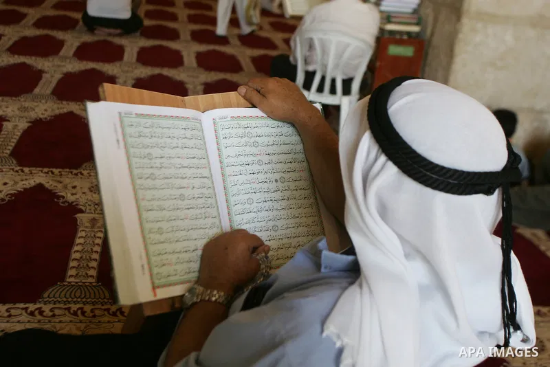 A Palestinian man reads the holy koran on the first day of holy fasting month of Ramadan. Throughout the holy month of Ramadan devout Muslims must abstain from food, drink and sex from dawn until sunset when they break t...