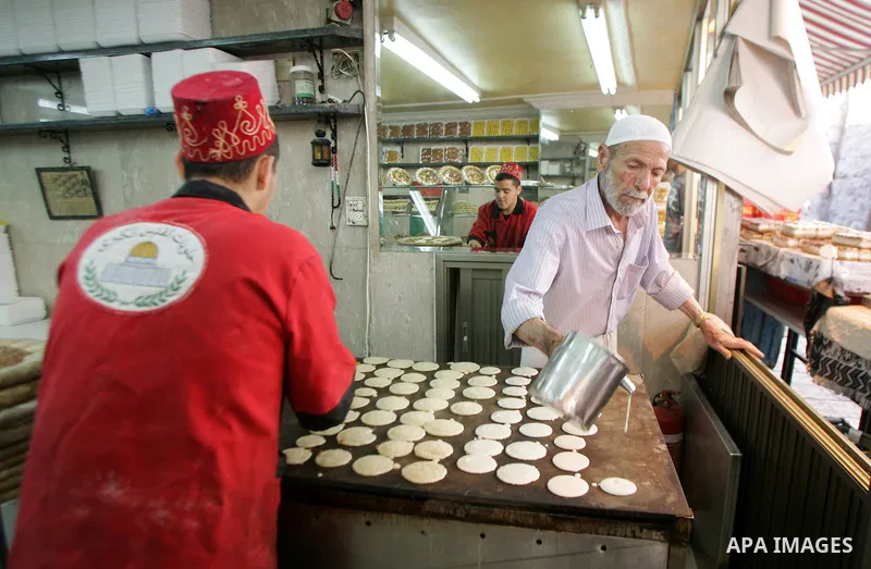 A Palestinian vendor prepares qatayef, a traditional pancake for Ramadan, before selling it at a shop in the old city of jerusalem August 2, 2011. Muslims around the world abstain from eating, drinking and conducting sex...