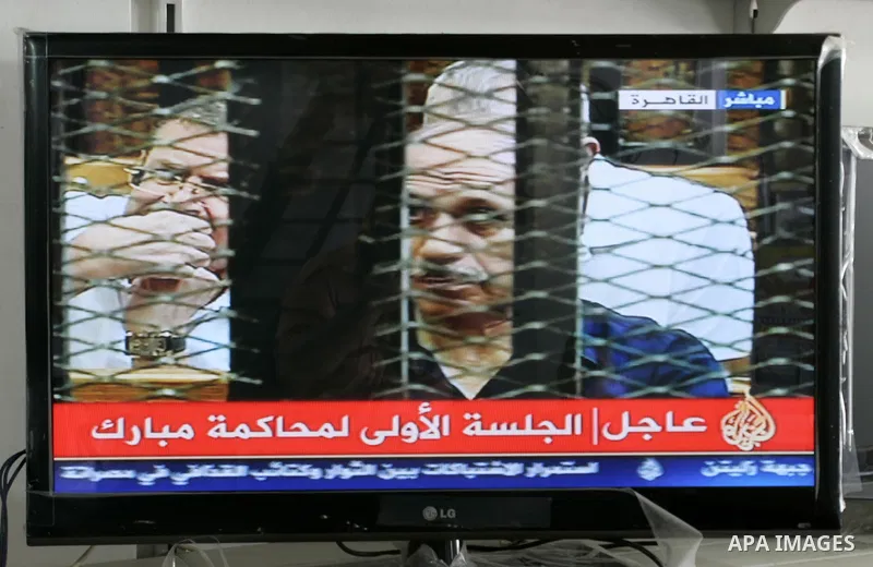 This video image taken from Egyptian State Television shows former Egyptian interior minister Habib el-Adly, in a cage of mesh and iron bars in a Cairo courtroom Wednesday Aug. 3, 2011. An ailing, 83-year-old Hosni Mubar...
