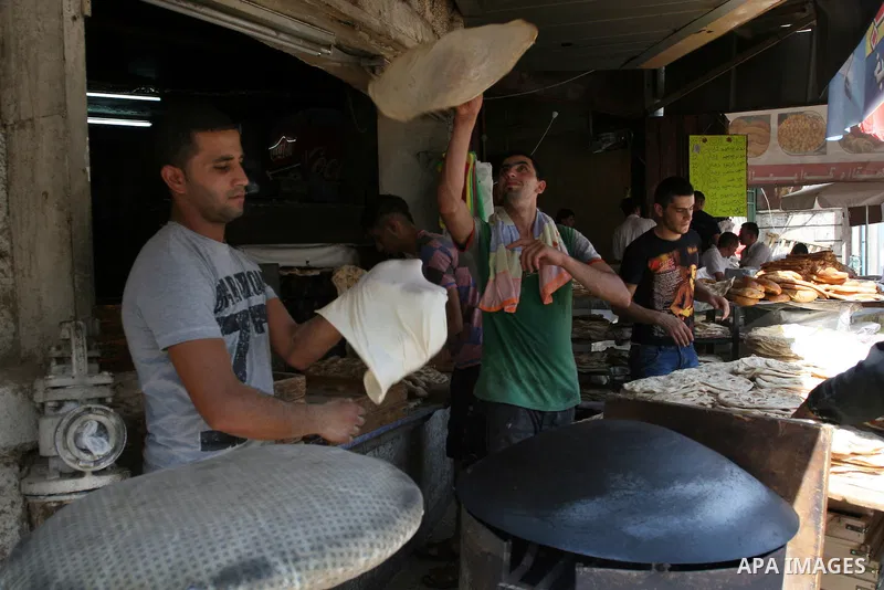 A Palestinian vendor bakes traditional bread on a fasting day of Ramadan in the West Bank city of Ramallah, on Aug. 3, 2011. Muslims around the world abstain from eating, drinking and conducting sexual intercourse from s...