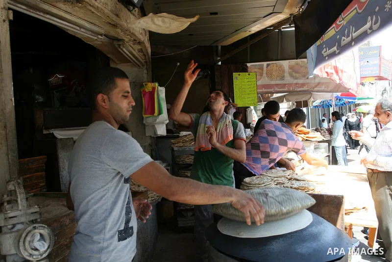 A Palestinian vendor bakes traditional bread on a fasting day of Ramadan in the West Bank city of Ramallah, on Aug. 3, 2011. Muslims around the world abstain from eating, drinking and conducting sexual intercourse from s...