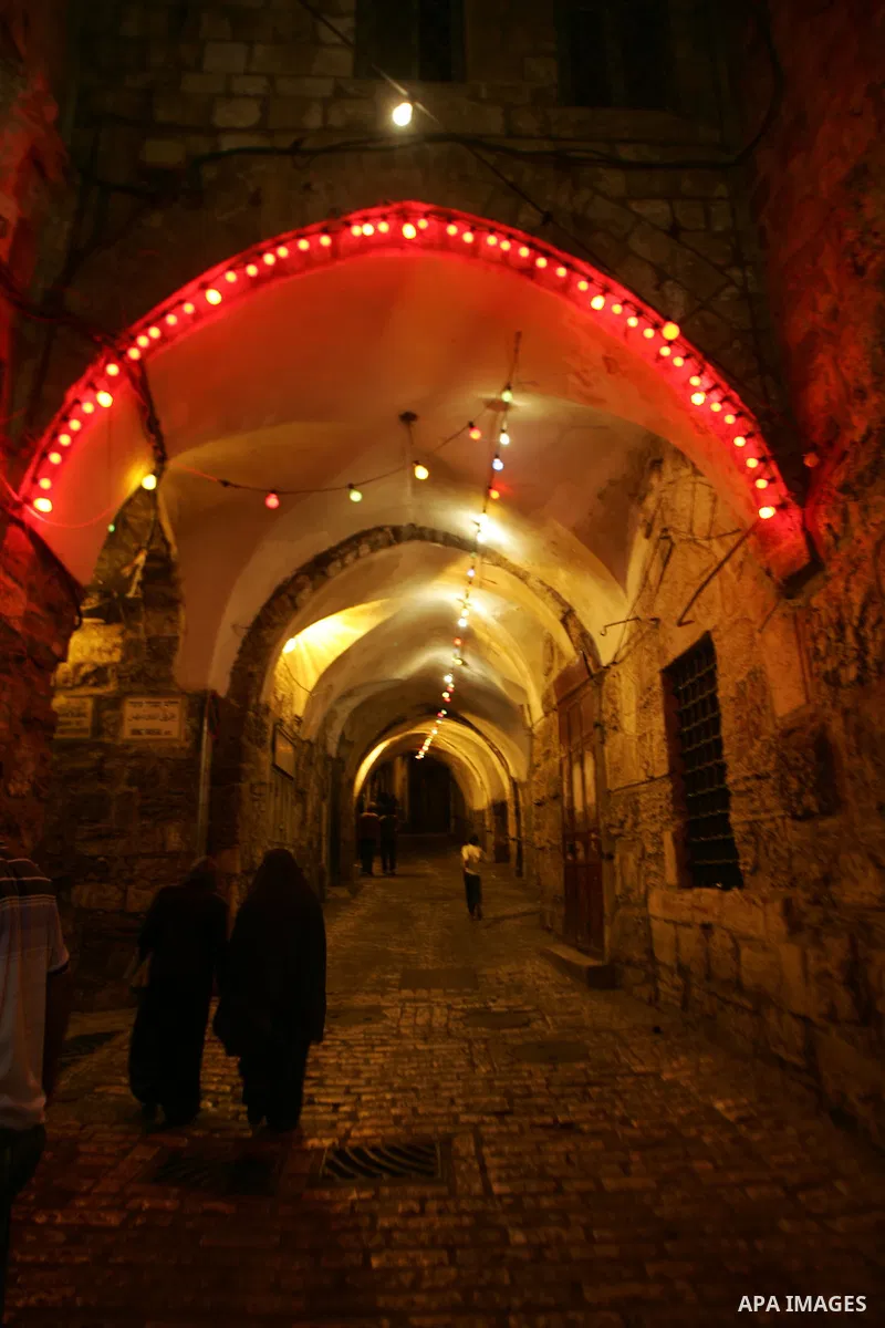 Palestinians walks under decorations in the nights of the holy month of Ramadan in Jerusalem's Old City on Aug. 3, 2011. Muslims around the world abstain from eating, drinking and sexual relations from sunrise to sunset...
