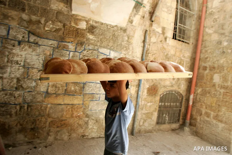 A Palestinians boy sells traditional bread in the holy month of Ramadan in Jerusalem's Old City on Aug. 3, 2011. Muslims around the world abstain from eating, drinking and sexual relations from sunrise to sunset during R...