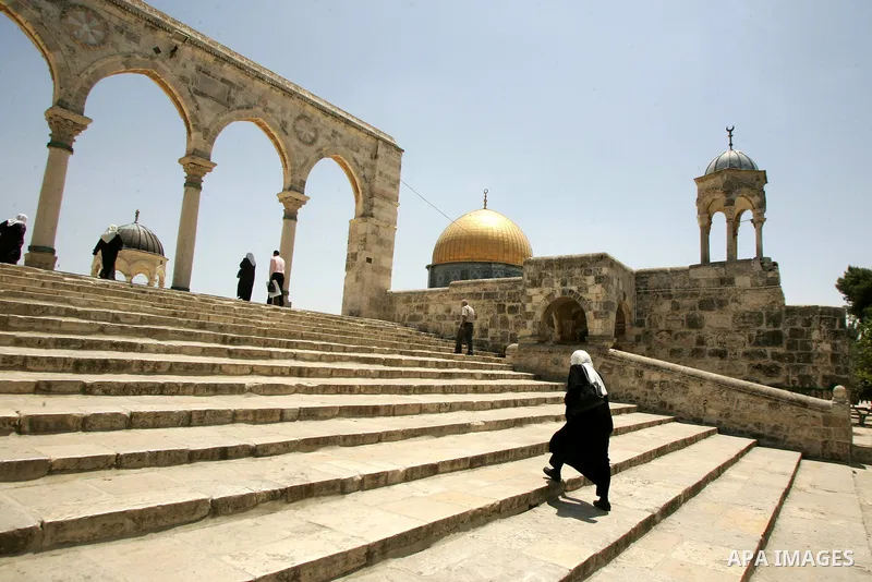A Palestinian woman walks at the entrance of the Al-Aqsa mosque compound, in the old city of Jerusalem, on Aug, 3, 2011, Muslims around the world abstain from eating, drinking and conducting sexual relations from sunrise...
